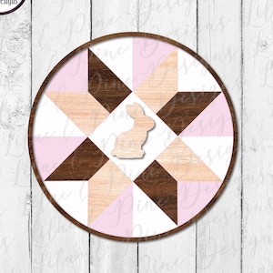 May include: A round wooden sign with a pink and white quilt pattern and a small bunny cutout in the center. The sign is perfect for Easter decor.