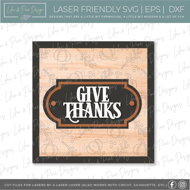 May include: A wood-grain background with a black frame and a brown sign that says "GIVE THANKS" in white letters. The sign has a decorative border and a brown background.