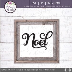 May include: A black and white sign with the word "Noel" in a cursive font. The sign is framed in a rustic wooden frame.