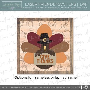 May include: A Thanksgiving-themed wood sign with a turkey holding a sign that says "Give Thanks". The turkey is brown with a red, orange, and brown feather design. The sign is surrounded by a brown wood frame.