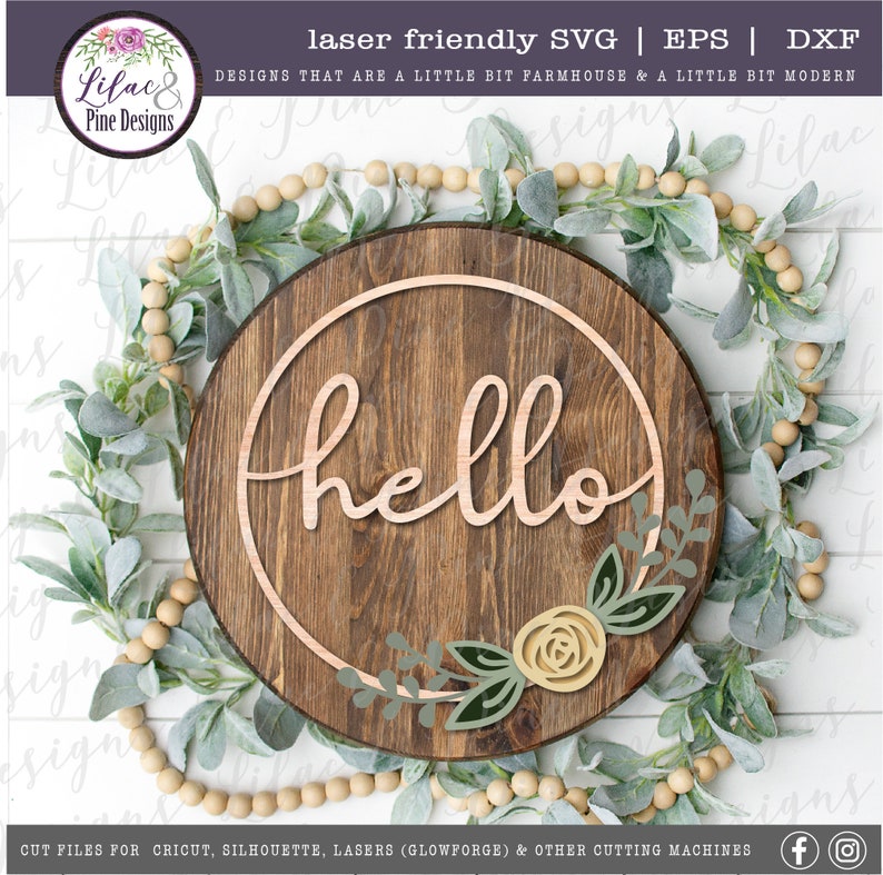 May include: A wooden round sign with the word "hello" in a cursive font inside a circle. The sign is decorated with a floral design with green leaves and a yellow rose.