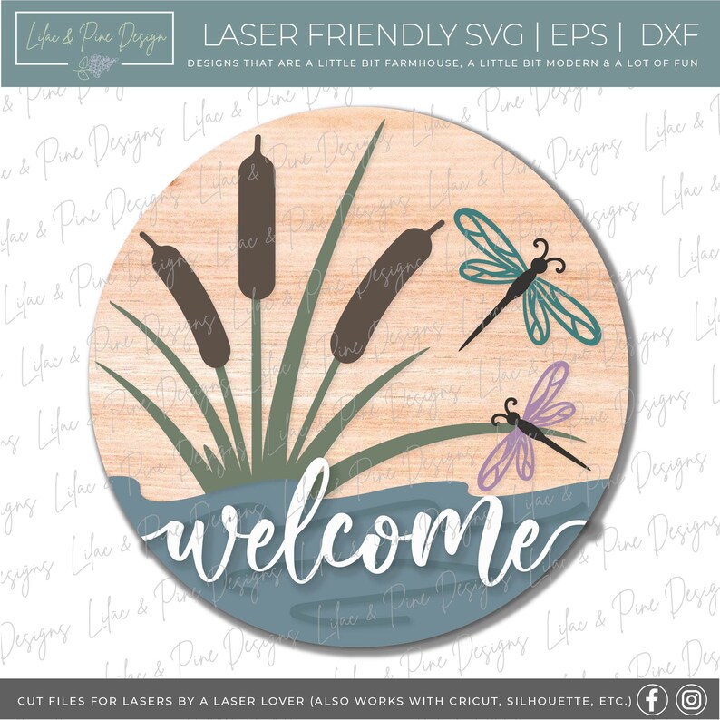 May include: A round wooden sign with a blue water scene and the word "welcome" in white. The sign features brown cattails, green reeds, and two purple and teal dragonflies.