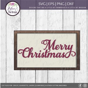 May include: A brown wooden frame with a white background and the text "Merry Christmas" in a burgundy cursive font.