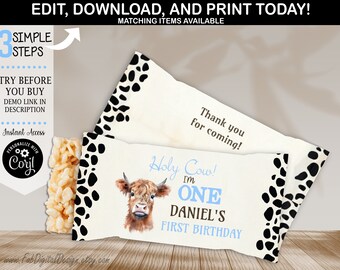 May include: Printable party favor wrapper featuring a cartoon Highland cow with the text "Holy Cow! I'm One Daniel's First Birthday" in blue and black text on a white background with black and white cow print border.