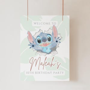 May include: A welcome sign for a 10th birthday party featuring Stitch from Lilo & Stitch. The sign has a light blue background with green leaves and the text "Welcome to Maleah's 10th Birthday Party".