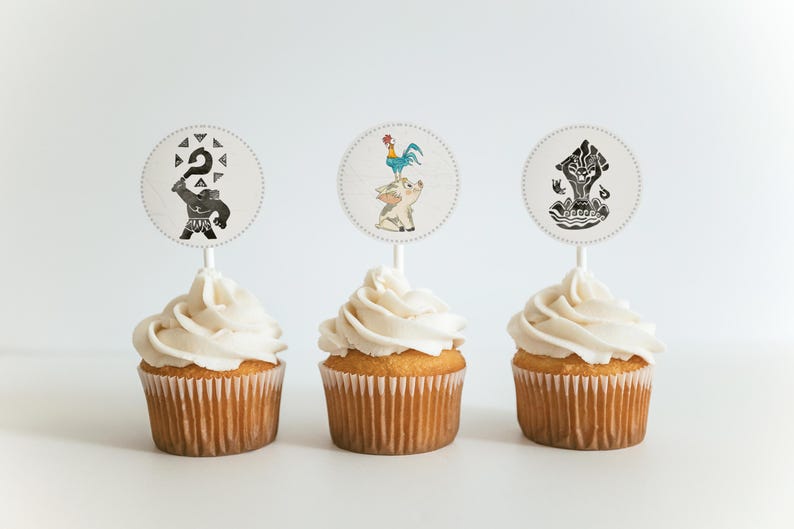 May include: Three cupcakes with white frosting and decorative toppers. The toppers feature black and white illustrations of characters. The cupcakes are on a white surface, creating a clean and appealing presentation. Perfect for a themed party or celebration.