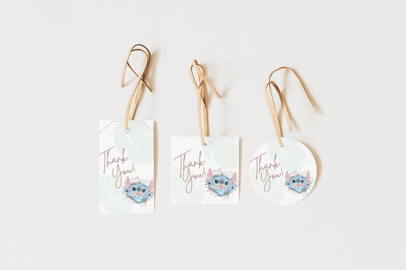 May include: Three thank you tags featuring a cartoon character on each. The tags are rectangular and round. The character is blue with large eyes and a pink nose. The text on the tags reads "Thank You!" in a pink cursive font.