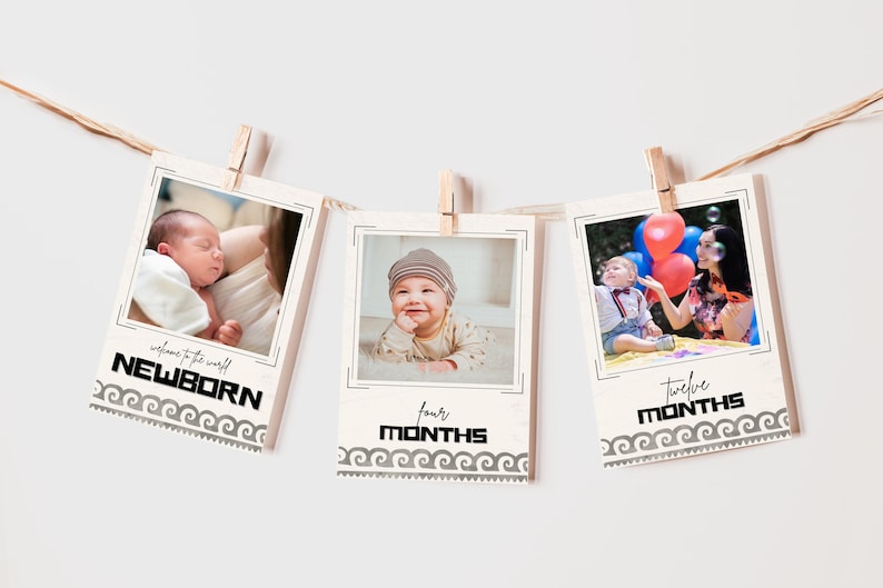 May include: Three baby milestone photo prints hanging from a string with clothespins. The prints feature photos of a baby at newborn, four months, and twelve months. Each print has text and a decorative border.