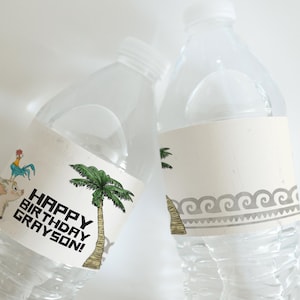 May include: Two clear plastic water bottles with white labels. One label says "HAPPY BIRTHDAY GRAYSON!" with a cartoon pig, rooster, and palm tree. The other label has a wave pattern.