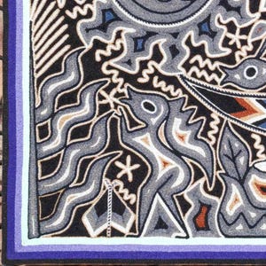 May include: A rectangular textile wall hanging featuring a black background with intricate, raised embroidery in shades of gray, white, blue, and brown. The design includes stylized figures, wavy lines, and geometric patterns with a purple border.