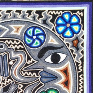 May include: A rectangular textile wall hanging featuring a central gray crescent moon with a face, surrounded by intricate black, white, blue, and brown geometric patterns. The design includes a blue flower and a purple border frame.