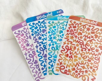 Puede incluir: Cuatro hojas de pegatinas con patrones coloridos con un diseño degradado. Las pegatinas presentan una variedad de formas, incluyendo estrellas, corazones y líneas onduladas. El texto "Lots Liv. Stef" está impreso en cada hoja.