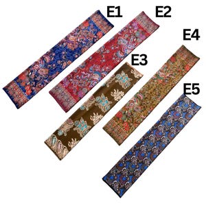 May include: Five rectangular scarves labeled E1 through E5. E1 is blue with floral patterns. E2 is red with intricate floral designs. E3 is brown with turquoise and cream motifs. E4 is olive green with dense floral patterns. E5 is blue with circular paisley motifs.