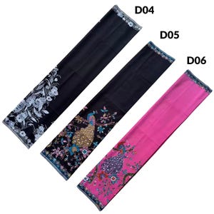 May include: Three rectangular fabric panels labeled D04, D05, and D06. D04 is black with a white floral pattern. D05 is black with a colorful peacock and floral design. D06 is bright pink with a colorful peacock and floral design on the edge.