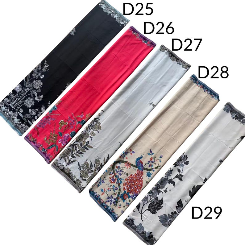 May include: Five rectangular fabric scarves labeled D25 through D29. D25 is black with white floral patterns. D26 is bright pink with floral and butterfly designs. D27 is white with grey foliage. D28 is beige with a peacock motif. D29 is white with black floral prints.