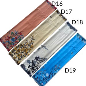 May include: Four rectangular fabric pieces labeled D16, D17, D18, and D19. D16 is dusty rose with a colorful floral print. D17 is cream with yellow and brown floral patterns. D18 is white with black floral designs. D19 is bright blue with blue floral motifs.