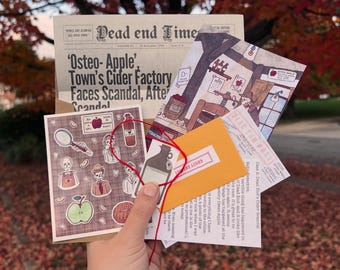 May include: A collection of printed paper items including a Dead End Times newspaper, a Dead End Post letter, a small yellow envelope, and a card featuring illustrated skeletons, apples, and cider bottles, all tied together with a thin red string.