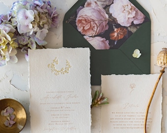 May include: Elegant wedding stationery set featuring a floral design. The set includes invitations, RSVP cards, and envelopes with a botanical theme. The color palette includes white, green, and pink, with gold accents. A vintage postage stamp is also included.