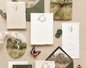 May include: An assortment of wedding stationery, including invitations, menus, and envelopes, arranged on a neutral surface. The invitations feature elegant calligraphy and botanical illustrations. Decorative butterflies and wax seals add a touch of nature and sophistication to the design.