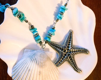 May include: A necklace with blue and silver beads, a white seashell pendant, and a silver starfish pendant.