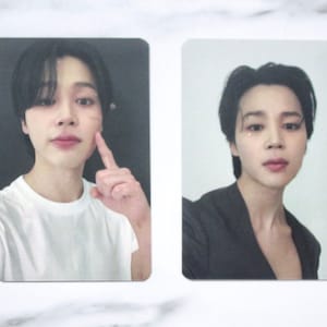 May include: Two photo cards featuring a man with black hair. The man on the left is wearing a white t-shirt and has a black background. The man on the right is wearing a black blazer and has a white background.