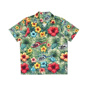 May include: A short-sleeved button-up shirt with a tropical print featuring helicopters, hibiscus flowers, and palm leaves in shades of green, red, yellow, blue, and white.