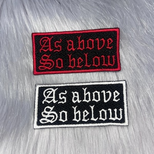 May include: Two rectangular embroidered patches featuring the text As above So below in a gothic font. One patch has a black background with red text and a red border, while the other has a black background with white text and a white border.