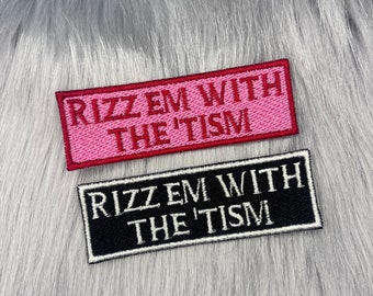 May include: Two iron-on patches with the text "Rizz Em With The 'Tism" in white and red lettering on a black and pink background.