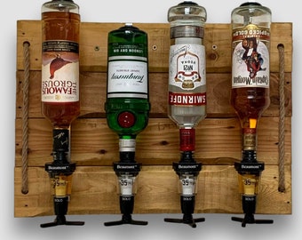 May include: A wooden wall-mounted liquor dispenser with four bottles. The bottles are labeled "The Famous Grouse", "Tanqueray", "Smirnoff No. 21 Vodka", and "Captain Morgan Spiced Gold". Each bottle has a black spout with a label that reads "Beaumont" and "35ml".