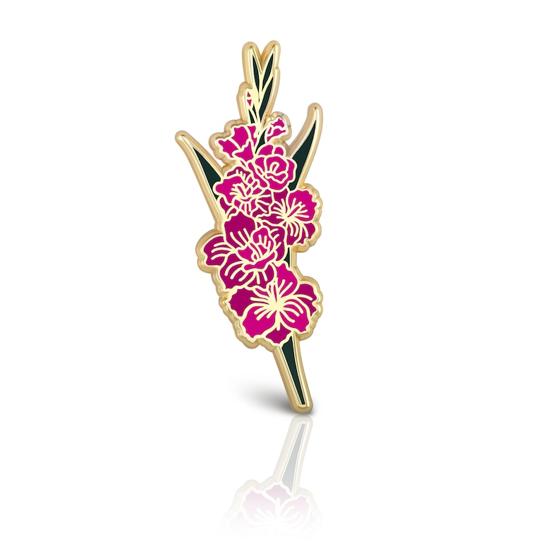 May include: Gold-toned enamel pin featuring a pink gladiolus flower with green leaves.