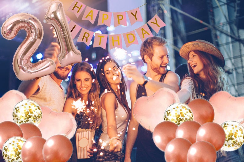 May include: A group of friends celebrating a 21st birthday with rose gold balloons, confetti balloons, and a pink banner that says "Happy Birthday".