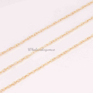 May include: A gold-colored metal chain featuring a series of small, uniform oval links connected in a continuous strand. The text Wholesalegemco is printed in a dark font across the center of the chain segments, which are arranged diagonally.