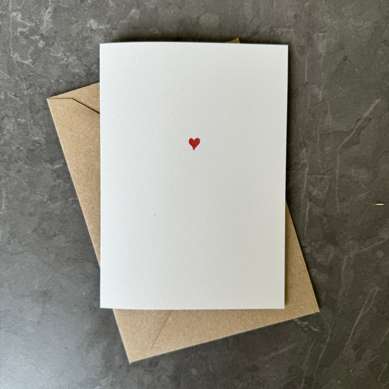 Simple tiny red love heart printed on recycled white card.  Blank inside for your own message