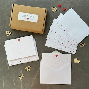 10 notecard postcards with a single red heart and 10 white envelopes with heart pattern along the bottom