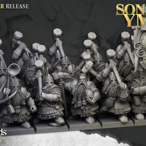 May include: A set of nine grey plastic miniature figures of dwarves wielding hammers, standing on rectangular bases. The figures are part of a Sons of Ymir set, a fantasy miniatures line. The text "SEPTEMBER RELEASE" is visible in the top left corner of the image.