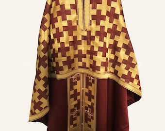 May include: A liturgical vestment featuring a deep burgundy base color with a prominent gold-colored yoke and vertical panel. The upper section and sleeves are adorned with a repeating pattern of dark red crosses on a gold background.