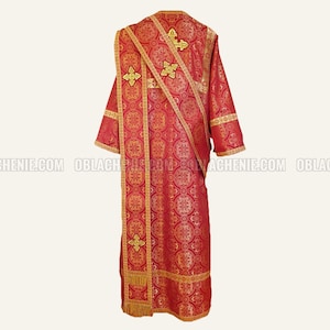 May include: A red liturgical vestment with gold embroidery and trim. The vestment has a decorative pattern and features a cross design.