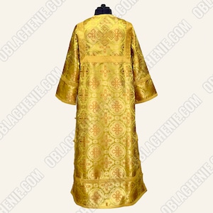 May include: A gold liturgical vestment with a cross pattern and gold trim.