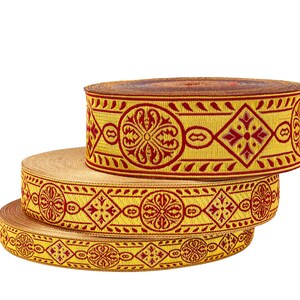 May include: Three rolls of gold and red patterned trim with intricate designs. The trim is woven with a repeating pattern of flowers and geometric shapes.