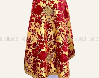 May include: A red and gold liturgical vestment with a floral pattern. The vestment has a cross embroidered on the back.