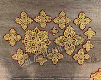 May include: A set of 13 gold and red embroidered cross patches. The crosses are various sizes and feature intricate designs.