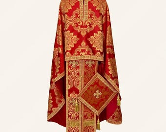 May include: A red and gold liturgical vestment set featuring intricate damask patterns, a central vertical panel with cross motifs, and a square-shaped accessory piece with a gold cross, all finished with decorative gold fringe trim.