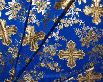 May include: Blue fabric with a repeating pattern of gold crosses and floral designs.