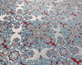 May include: White fabric with a repeating pattern of silver crosses, red and blue accents, and floral designs.