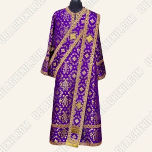 May include: A purple liturgical vestment with gold embroidery and trim. The vestment has a long, flowing design and is decorated with intricate floral patterns.
