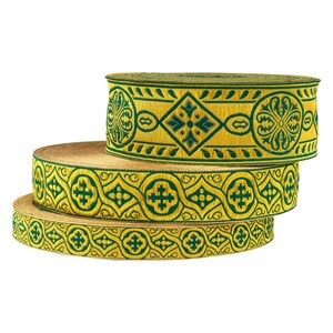 May include: Three rolls of gold and green patterned trim with intricate designs. The trim is woven with a repeating pattern of crosses, flowers, and geometric shapes.