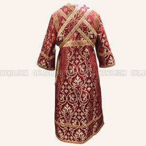 May include: A red liturgical vestment with gold embroidery and trim. The vestment has a cross pattern and floral designs.