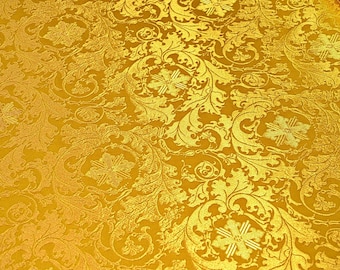 May include: Gold fabric with a repeating pattern of stylized leaves and flowers.
