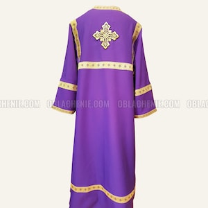 May include: Purple liturgical vestment with gold embroidery of a cross and trim. The vestment has a long, flowing design and is made of a soft, luxurious fabric.