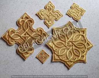 May include: Five gold embroidered patches with intricate floral designs. The patches are in the shape of a cross, a star, and three squares.